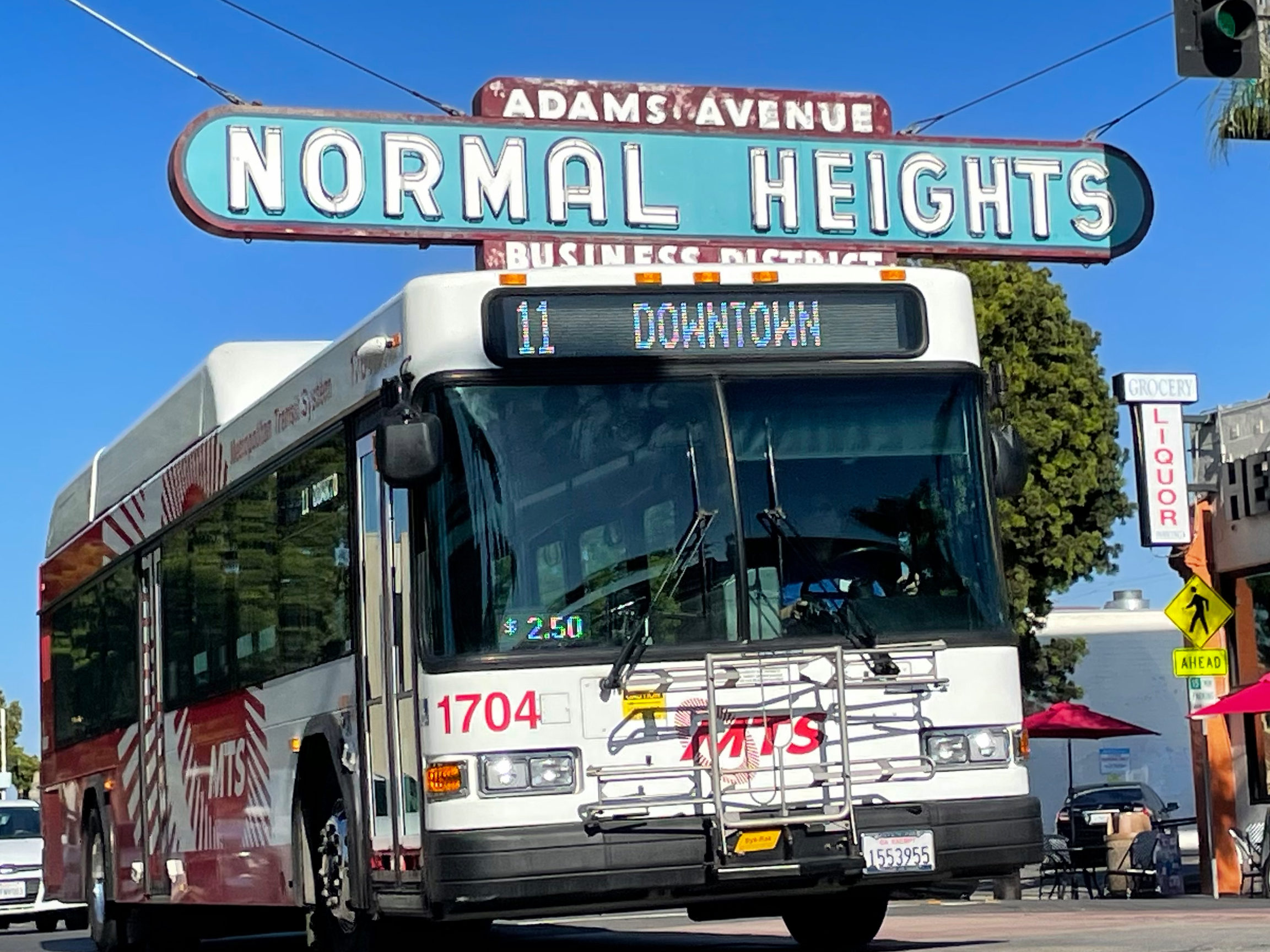 Number 11 bus in front of Normal Heights sign
